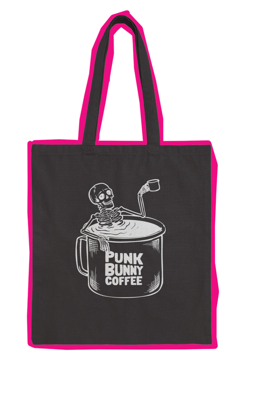 Black tote bag with pink handles featuring a skeleton and coffee cup design, labeled 'Punk Bunny Coffee'.